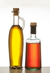 Olive oil and vinegar bottled isolated against white background.
