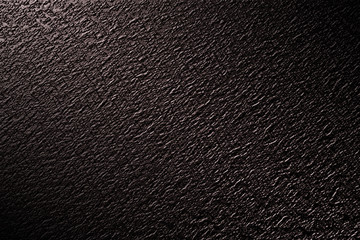 dark rock wall with light and shadow.