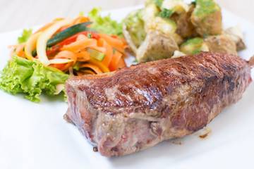Premium Meat Cut   Beef Cuts - Sterling Silver, accompanied by vegetables and potatoes