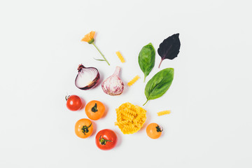 Dry uncooked fusilli pasta near tomatoes