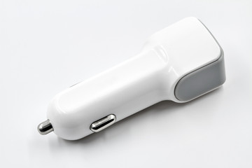White two port usb car charger on white background. Closeup.