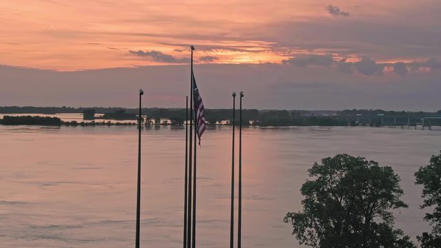 Aerial: American flag at Joe Curtis Point on Mud Island River Park. In the back is downtown Memphis. Tennessee, USA. 