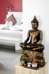 bronze buddha statue interior design detail in modern asian home