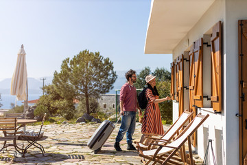 Young couple arriving to at holiday house 