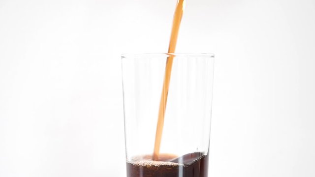 Cold cola being poured into a tall glass from the tap, on a white background, stock footage by Brian Holm Nielsen