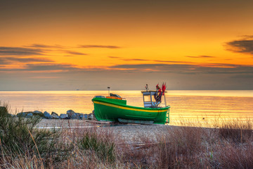 Fishing boats on the Baltic Sea beach at sunrise in Gdynia Orlowo, Poland