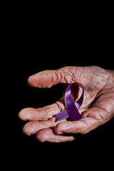 senior woman with a purple ribbon in her hand