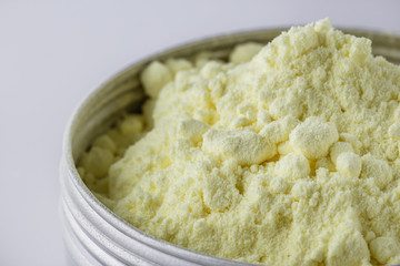 purified sulfur powder on a white acrylic background
