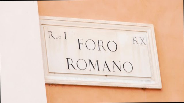 Close up of Foro Romano adress sign in Rome city, Italy. Forum Romanum white marble plate on building wall