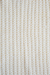 The texture of the fabric. White knitted pattern. background.
