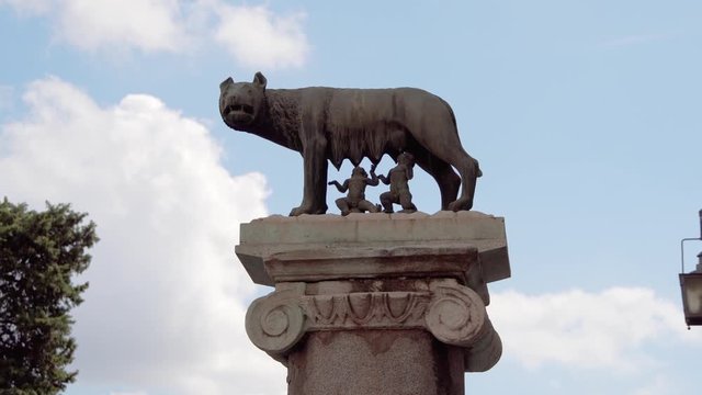 Statue of she-wolf on Capitoline hill against blue sky. Twins founders of Rome city - Romulus and Remus - suckling she-wolf. Icon of Italian capital Rome city