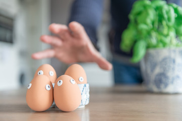 Clogged Easter eggs are found during the Easter breakfast at the kitchen table, the eggs are caught...