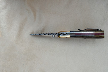 This is one beautiful and useful knife that anyone would love as a gift. Displayed on fabric there...