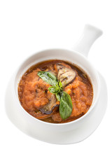 Squash zucchini or pumpkin paste puree with grilled eggplant and basil in white bowl isolated on white background