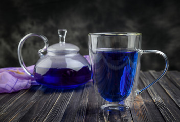 Cup and teapot butterfly pea flower blue tea. Healthy detox herbal drink.