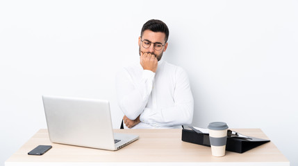 Young businessman in a workplace having doubts