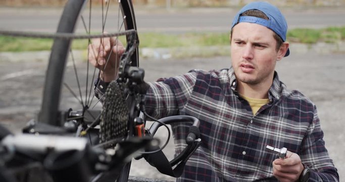 Disabled man assembling parts of a bicycle