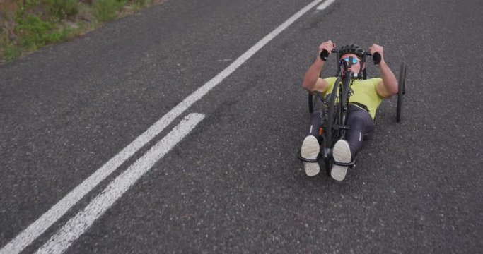 Disabled man riding a recumbent bicycle