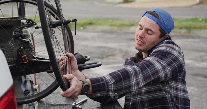 Disabled man assembling parts of a bicycle