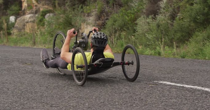 Disabled man riding a recumbent bicycle