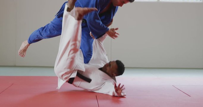 Judokas training by doing a randori on the judo mat