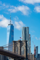 Arches on the Brooklyn Bridge with an American Flag and the Lower Manhattan New York City Skyline