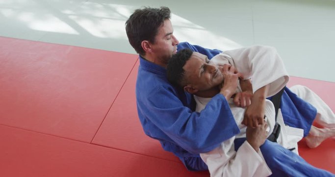 Judoka strangling his opponent on the judo mat