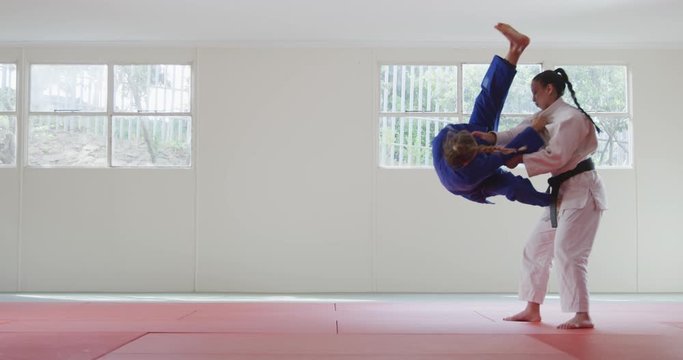Judokas fighting and immobilizing on the ground