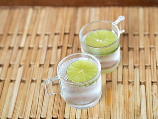 Bottom up Cup of lemonade soda light acid soft drink gin tonic  for detox hold in woman hand