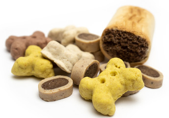 Different kinds of dog treats isolated on white background