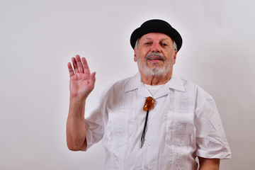 Cheerful old man waving.Elderly gentleman waving his hand.Senior man smiling and waving.