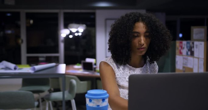 Businesswoman working on laptop in a modern office