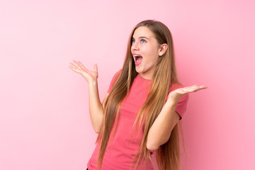 Teenager blonde girl over isolated pink background with surprise facial expression