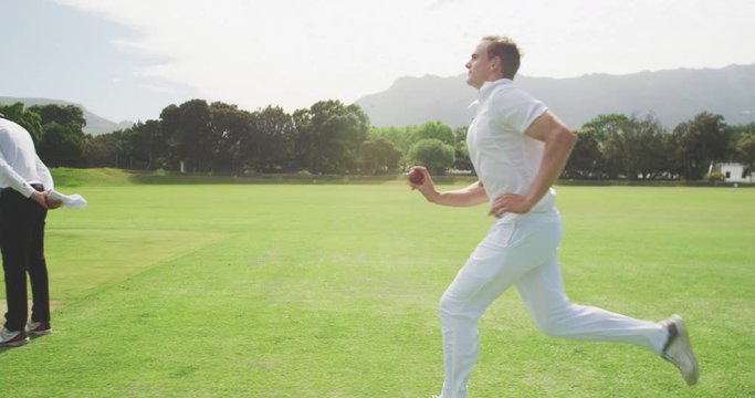 Side view of cricket payer throwing a ball