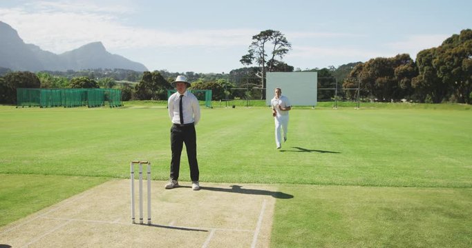 Cricket payer running and throwing a ball