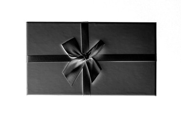 Black box with ribbon isolated on white background top view close up. Celebration holiday concept