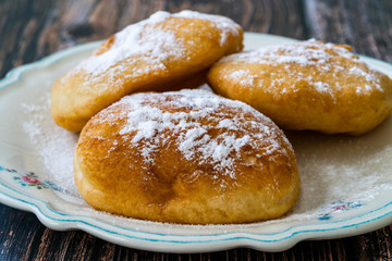 Mandazi is a slightly sweet East African Street Food; spicy, airy yeast doughnut dough made with...