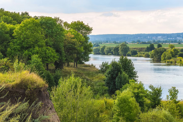 Obraz premium Summer landscape with river and forest on river bank_