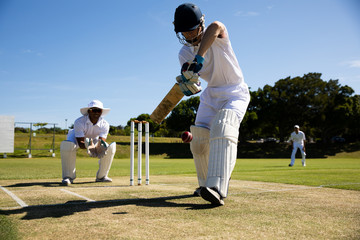 Cricket player shooting in the ball