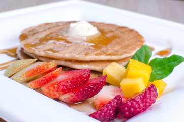 Pancakes, with chopped fruit and honey