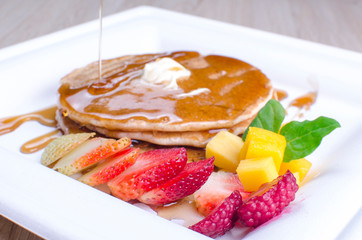 Pancakes, with chopped fruit and honey