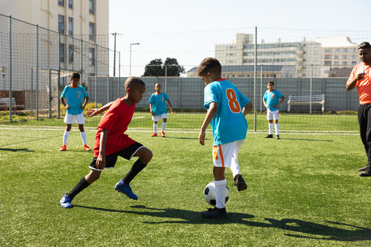 Children training to play soccer on the field