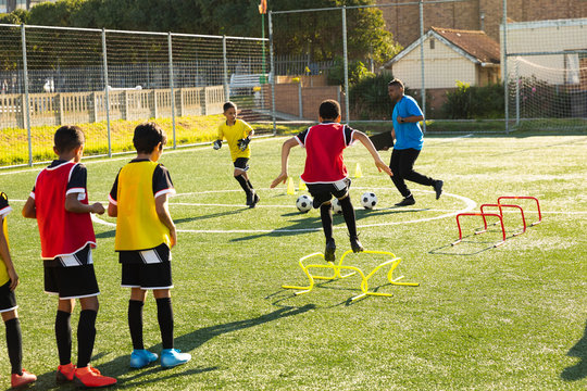 Children training before playing soccer on the field