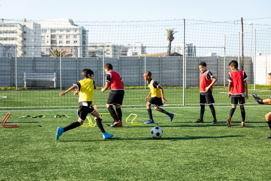 Children training to play soccer on the field