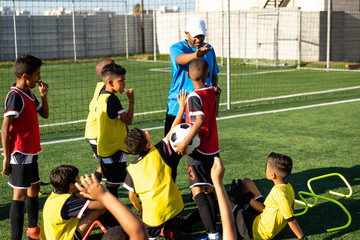 Soccer team looking at their coach