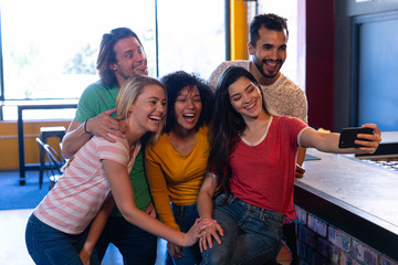 Friends taking selfies together