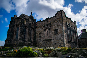 inside the castle in edimburgh city, scotland on the rocks with a blue sky at sunset