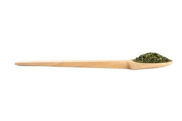 dried nettle herb or in latin Utricae folium in wooden spoon isolated on white background....