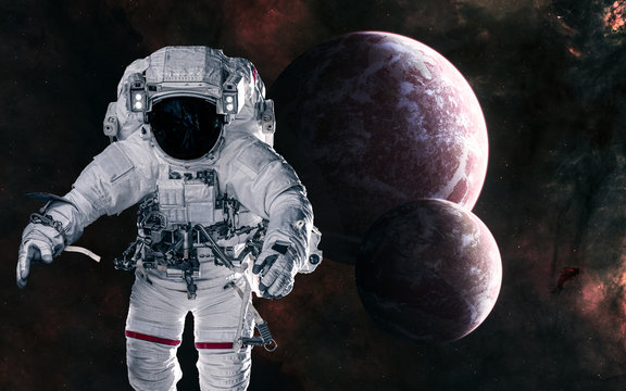 Astronaut on background of planets in deep space. Science fiction. Elements of this image furnished by NASA