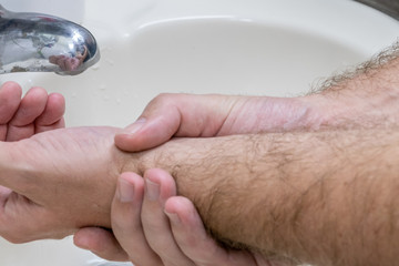 Man washing hands in basin close-up
